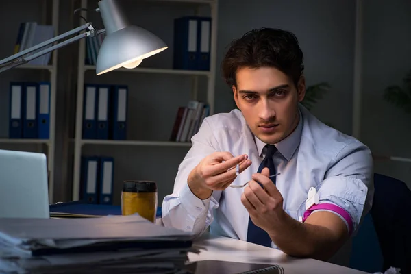 Mitarbeiter baut Stress durch Überstunden mit Drogen ab — Stockfoto