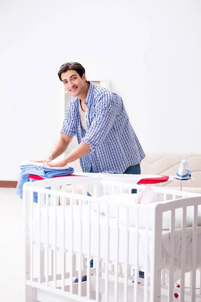 Young dad looking after newborn baby