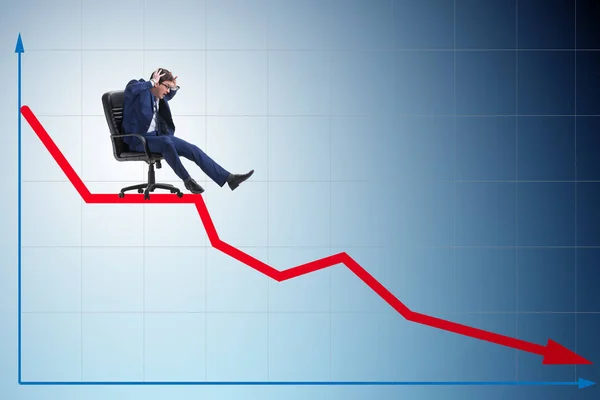 Businessman sliding down on chair in economic crisis concept — Stock Photo, Image