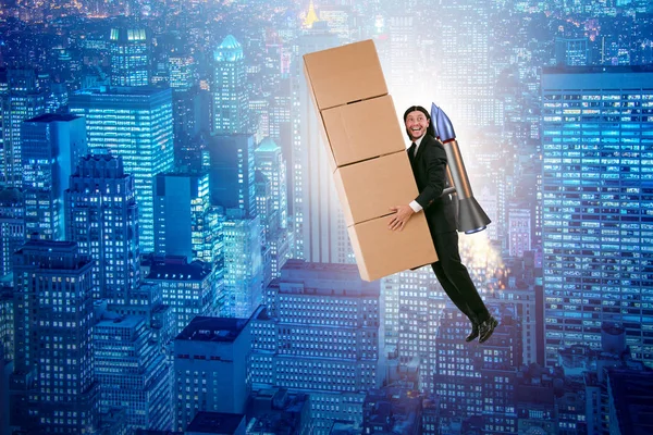 Businessman with jetpack delivering boxes globally — Stock Photo, Image