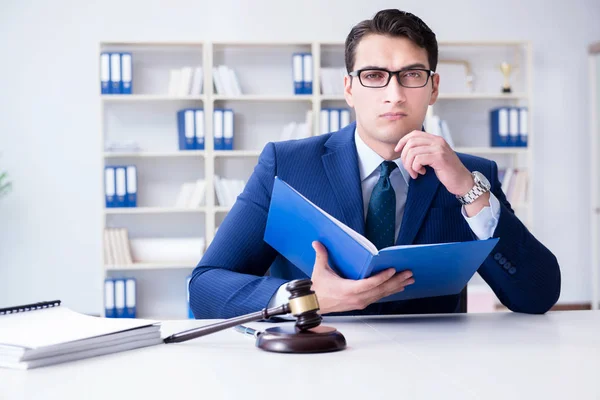 Young lawyer judge sitting in the office — Stock Photo, Image