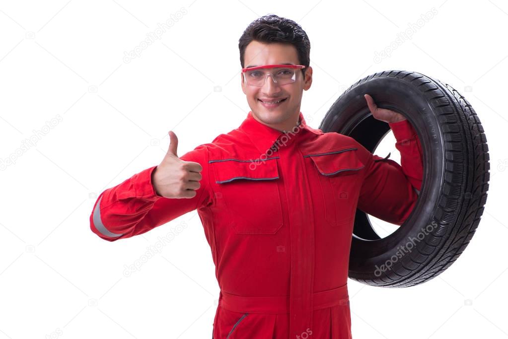 Young tyre repairman in red coveralls isolated on white backgrou