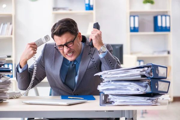 Desperate sad employee  tired at his desk in call center