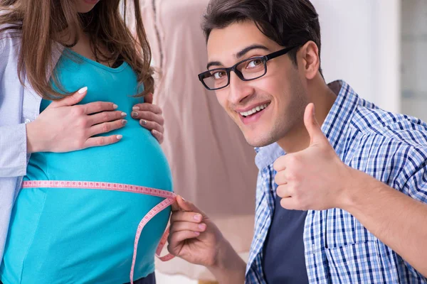 Pregnant woman visiting tailor for new clothing — Stock Photo, Image