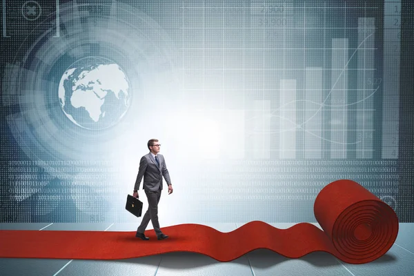 Businessman walking on red carpet — Stock Photo, Image