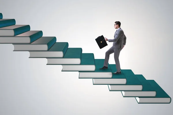 Businessman student climbing the ladder of education books — Stock Photo, Image