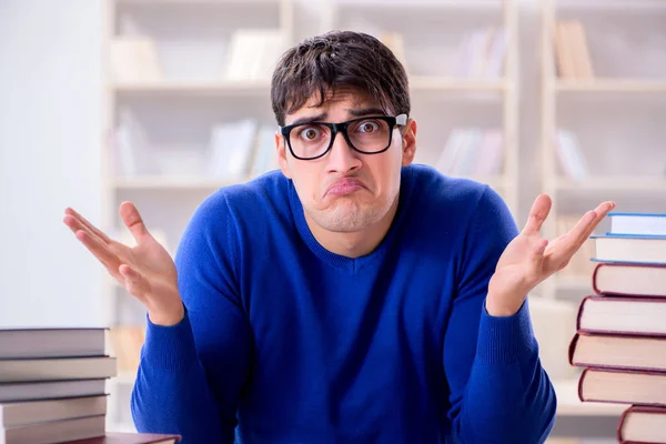 Male student preparing for exams in college library — Stock Photo, Image