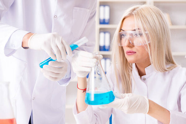 Young woman chemist working in clinic lab