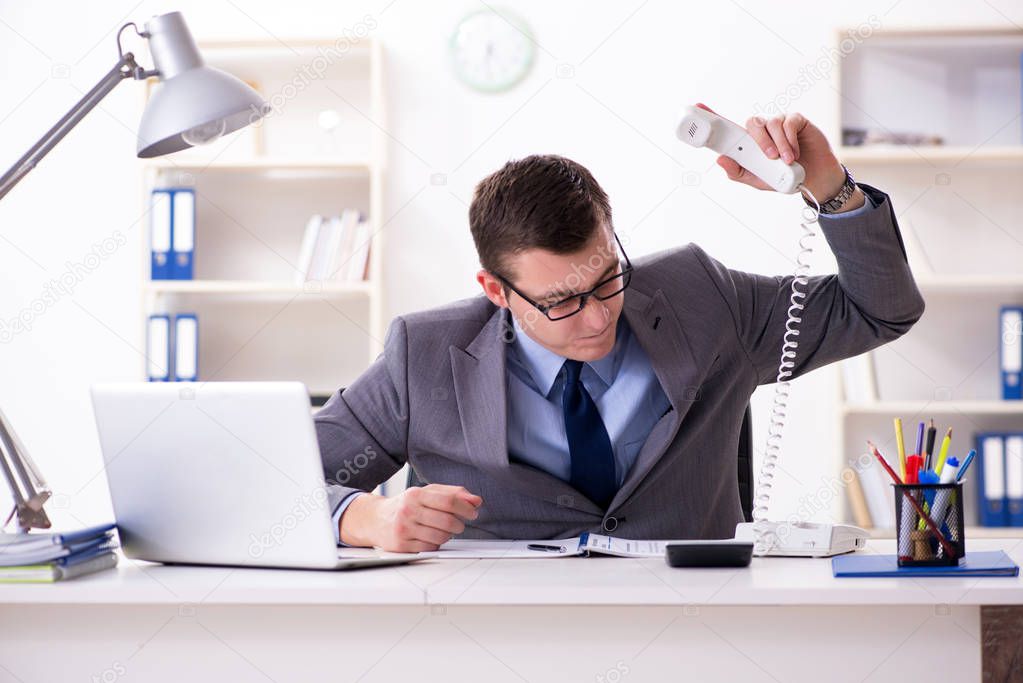 Businessman employee talking on the office phone