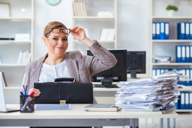 Businesswoman very busy with ongoing paperwork clipart