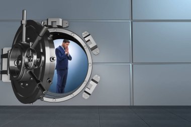 Businessman concerned about theft at banking vault door clipart