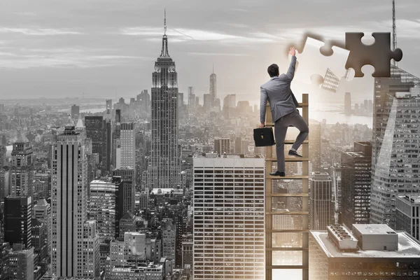 Businessman putting together jigsaw puzzle pieces — Stock Photo, Image