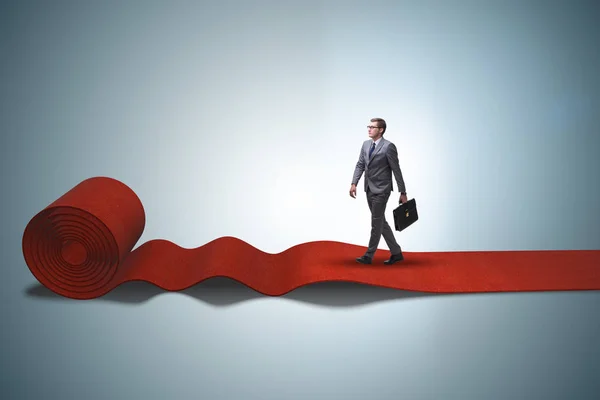 Businessman walking on red carpet — Stock Photo, Image