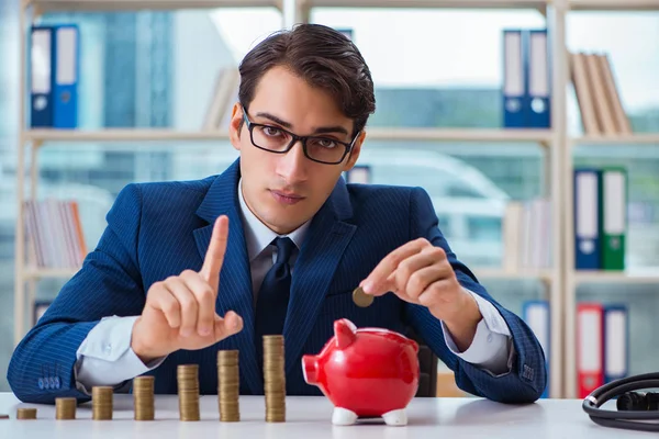 Empresario con pilas de monedas en la oficina — Foto de Stock