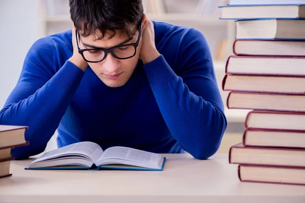Mannelijke student bereidt zich voor op examens in universiteitsbibliotheek — Stockfoto