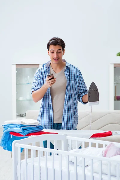 Young dad looking after newborn baby