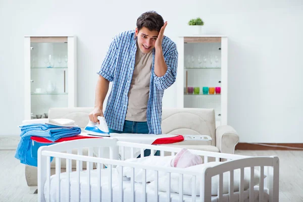 Young dad looking after newborn baby