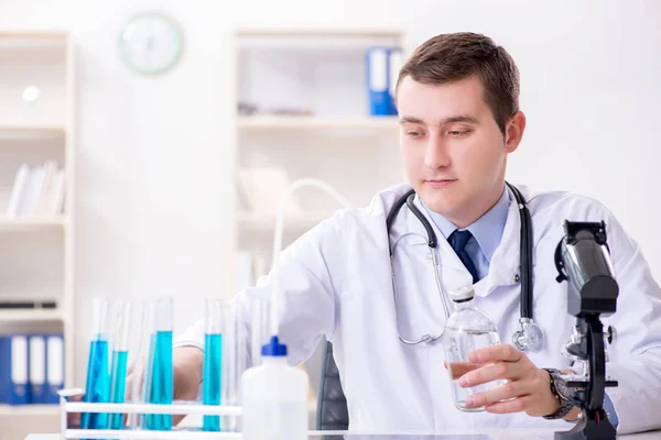 Male doctor looking at lab results in hospital