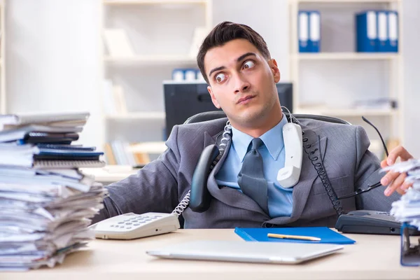 Desperate sad employee  tired at his desk in call center