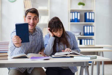 Sınıfta oturan ve okuyan öğrenciler