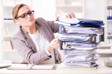 Businesswoman very busy with ongoing paperwork clipart