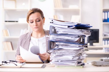 Businesswoman very busy with ongoing paperwork clipart