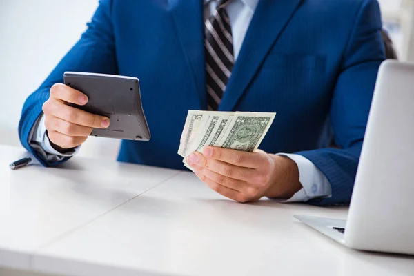 Accountant calculating dollars with calculator in office — Stock Photo, Image