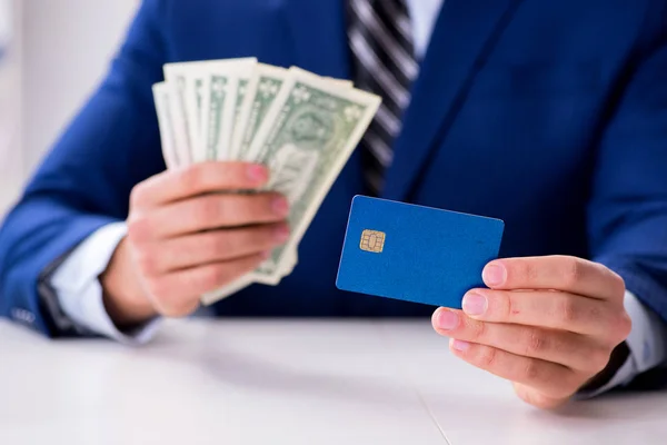 Businessman holding dollar money and credit card Stock Image
