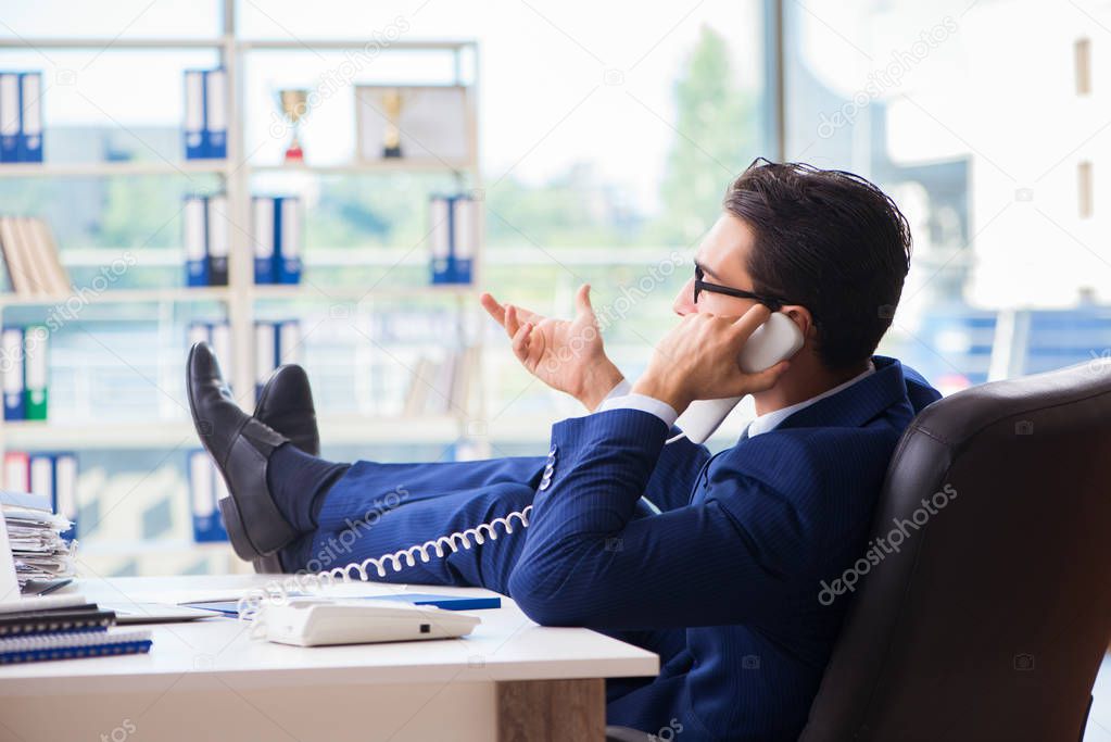 Businessman employee talking on the office phone