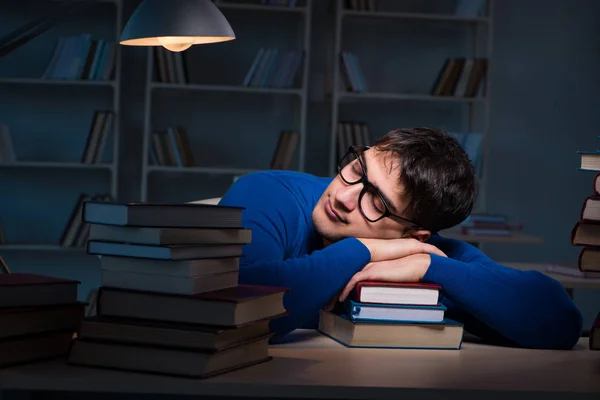 Estudiante preparándose para los exámenes tarde en la noche en la biblioteca — Foto de Stock