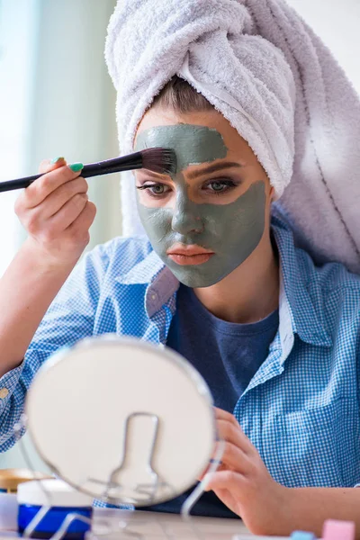 Kvinna tillämpa lera mask med borste hemma — Stockfoto