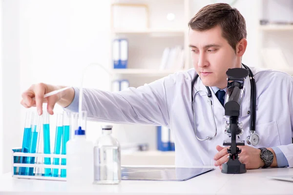 Male doctor looking at lab results in hospital — Stock Photo, Image