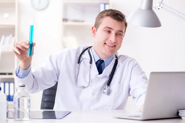 Male doctor looking at lab results in hospital