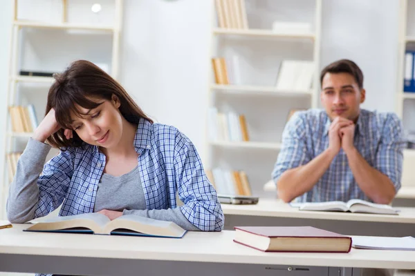 Students sitting and studying in classroom college Stock Image