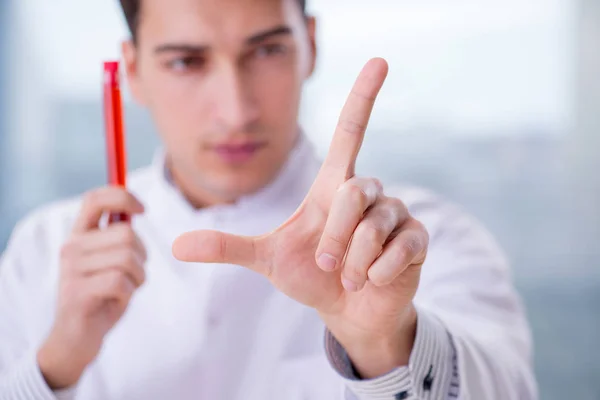 Man doctor checking blood samples in lab — Stock Photo, Image