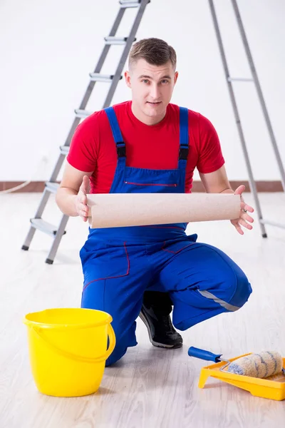 Contractor worker preparing for wallpaper decoration