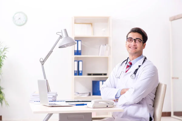 Young handsome doctor working in hospital room — Stock Photo, Image