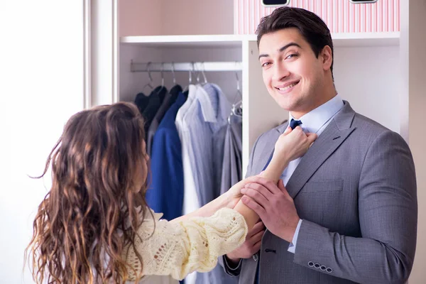 Wife helping husband to get dressed up — Stock Photo, Image