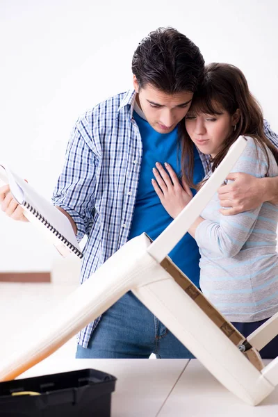 Esposa ayudando a marido a reparar silla rota en casa — Foto de Stock