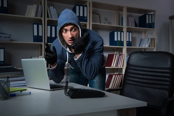 Young hacker hacking into computer at night — Stock Photo, Image