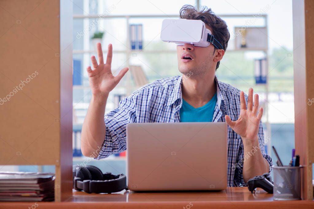 Young man playing computer game with virtual reality glasses