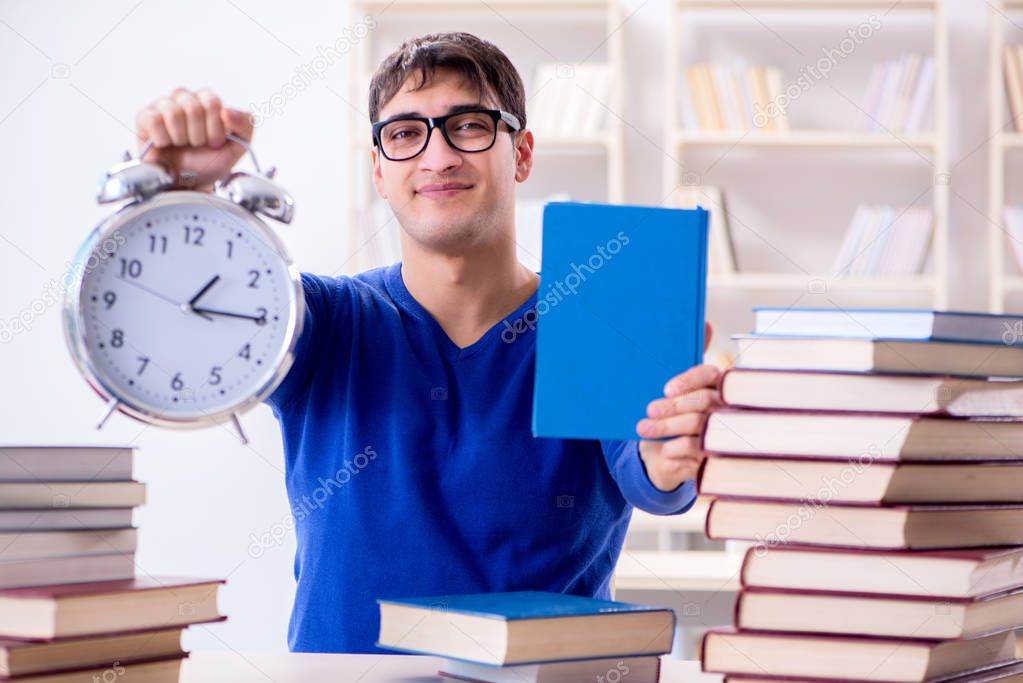 Male student preparing for exams in college library