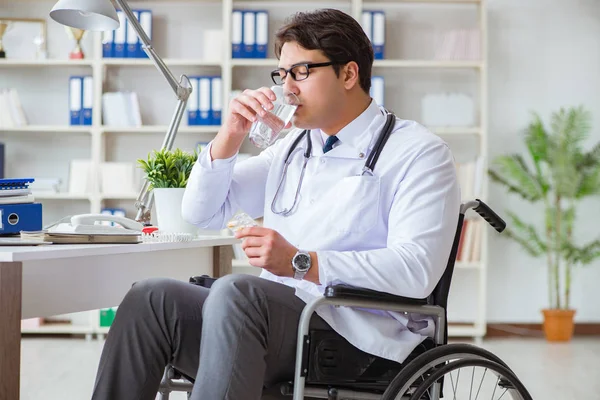 Disabled doctor on wheelchair working in hospital