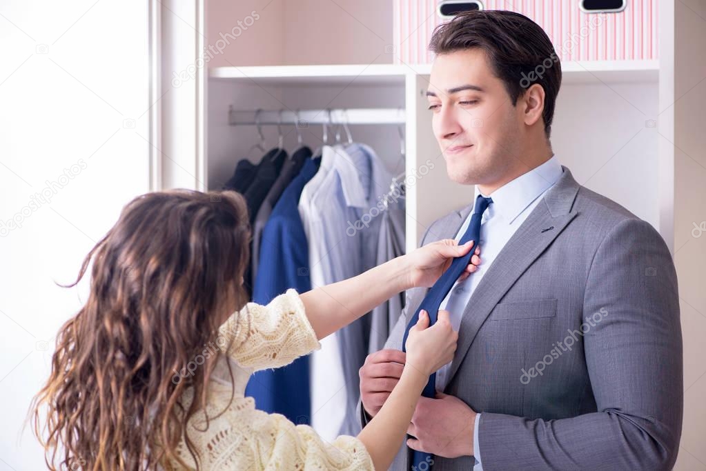 Wife helping husband to get dressed up