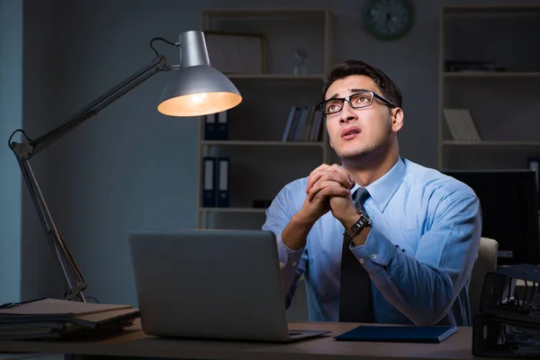 Employee working late at night at important report