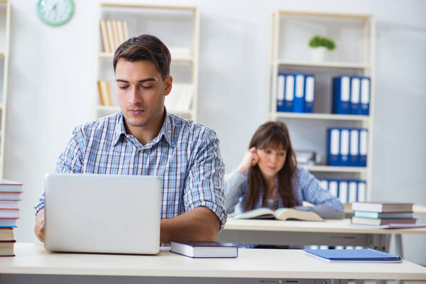 Students sitting and studying in classroom college