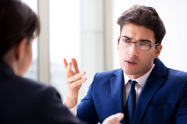 Lawyer talking to his client in office