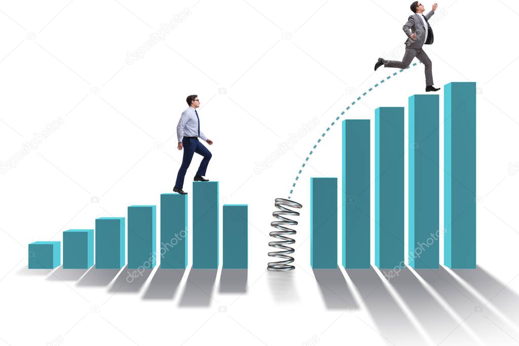 Business people jumping over bar charts