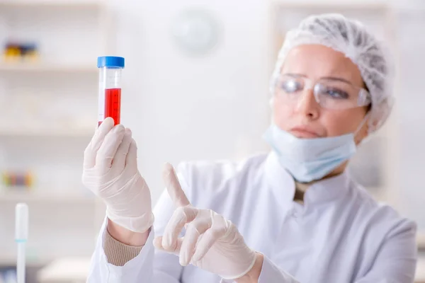 Mulher médico verificando amostras de sangue no laboratório — Fotografia de Stock