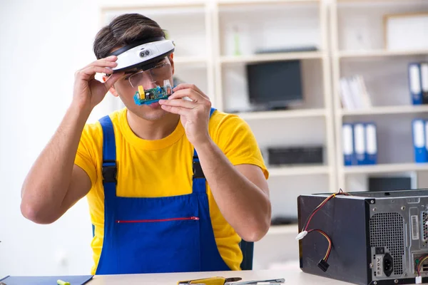 Computer repair technician repairing hardware